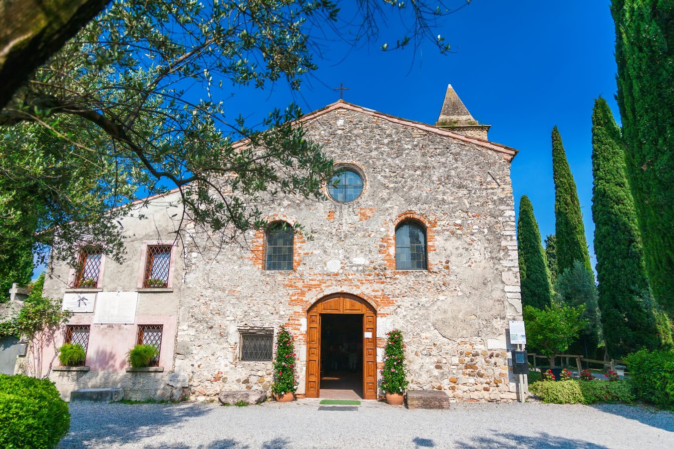 stone front facade of san pietro in mavino, the oldest church in sirmione italy