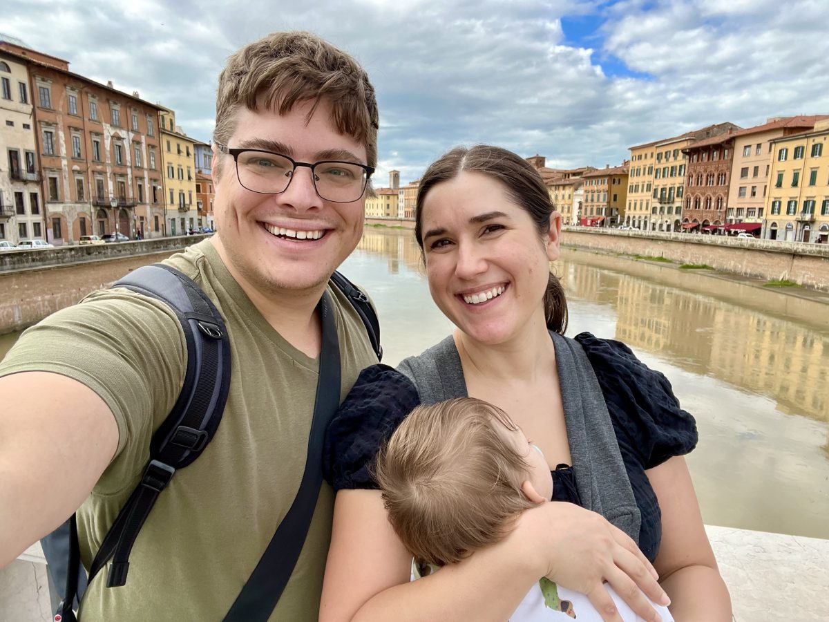 kate storm jeremy storm and their baby taking a selfie with the arno river when walking from the leaning tower of pisa to pisa centrale