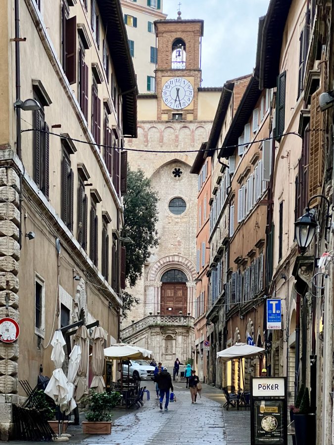 pedestrian street in perugia italy that dead ends into a clocktower