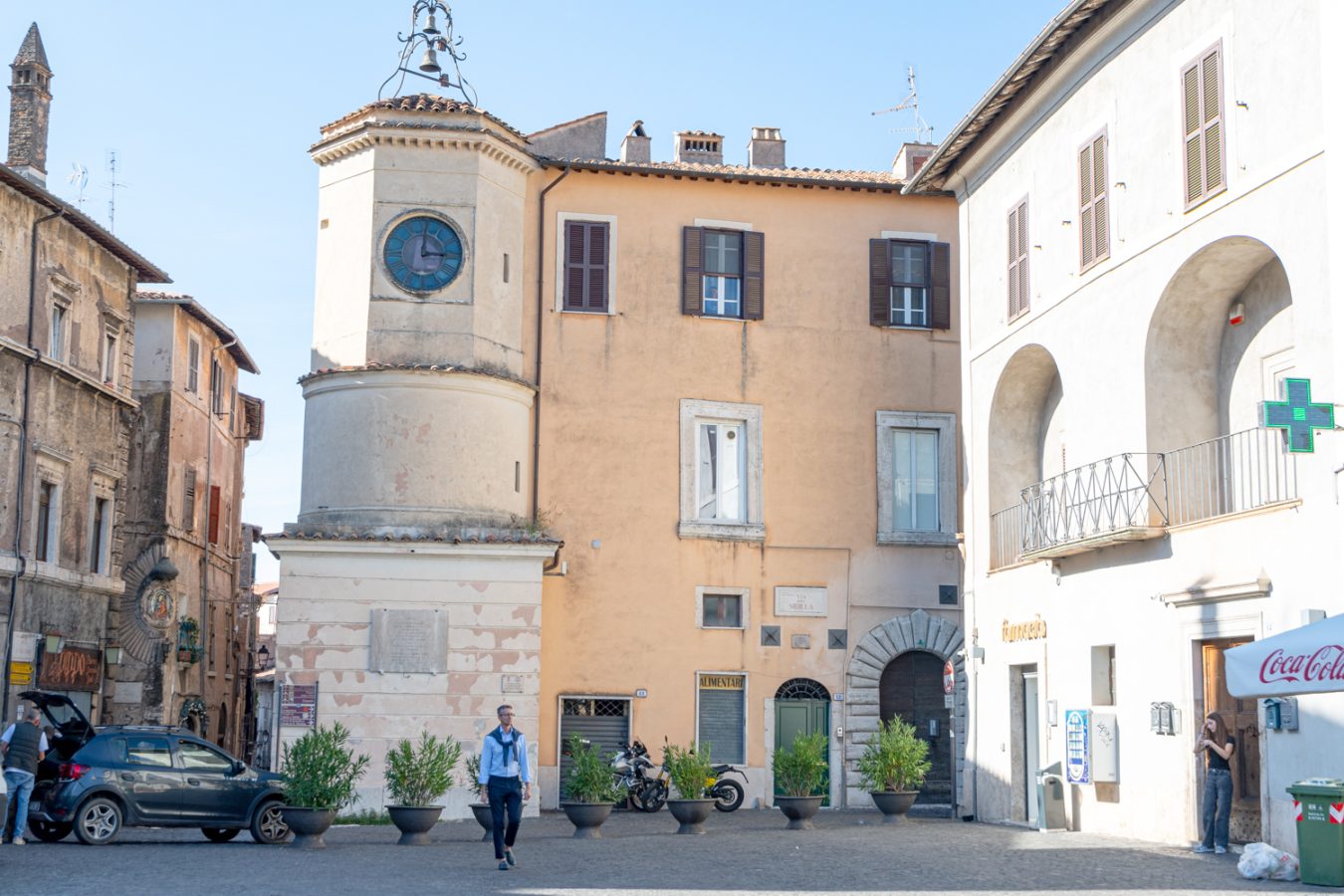 square in the historic center of tivoli with stone clock tower in the center