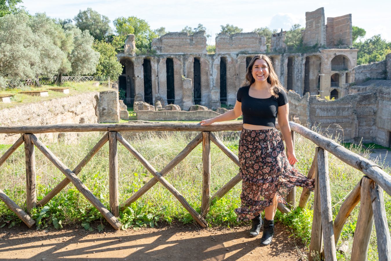 kate storm at an overlook at villa adriana in tivoli italy with roman ruins behind her