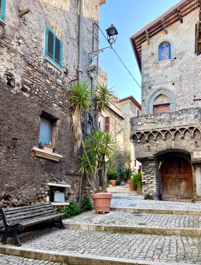 stone street in tivoli italy leading up to casa gotica with its stone staircase, one of the best places to visit in tivoli on a day trip from rome